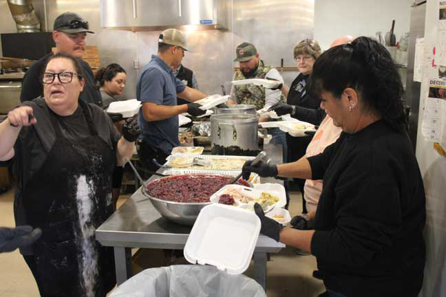 Volunteers prepare holiday meals for the homebound, those working